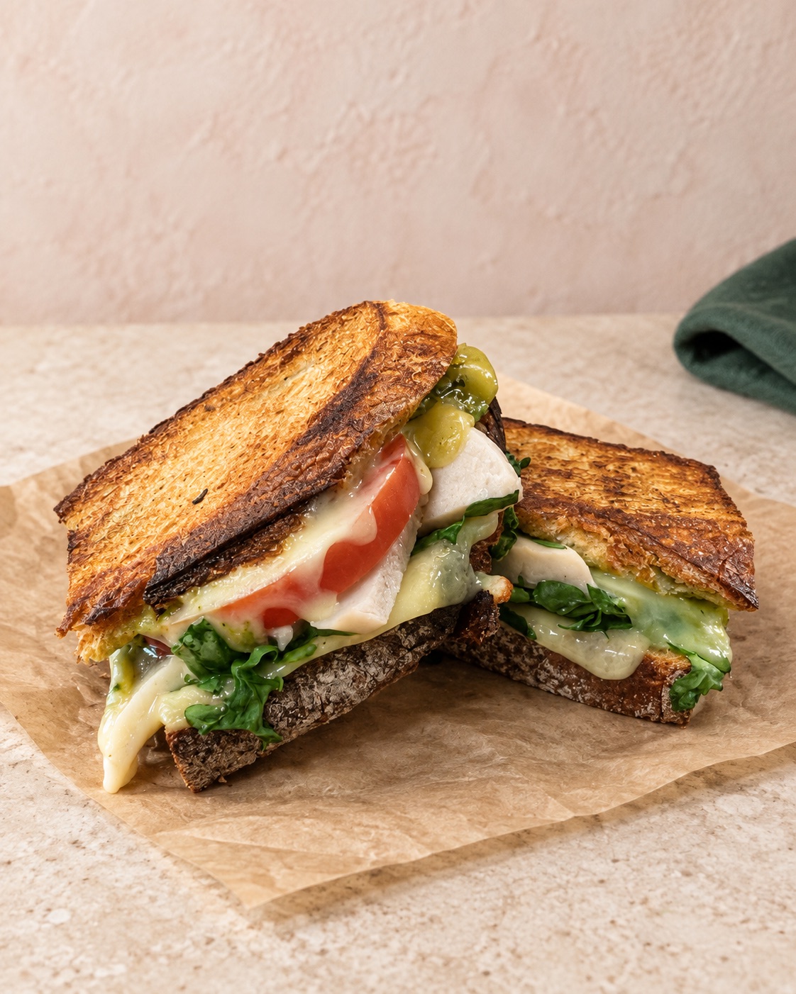 Toasted café sandwich with greens, tomato and melted cheese